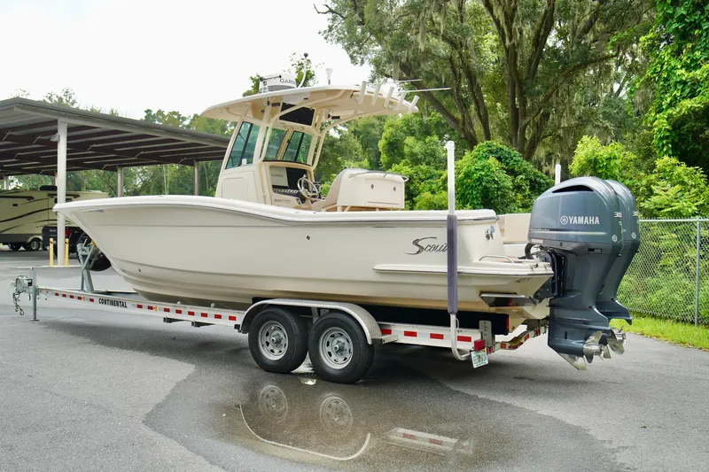 Slide: The Image of 2009 Scout 282 Sportfish boat on trailer with Yamaha engine, parked outdoors. - 24