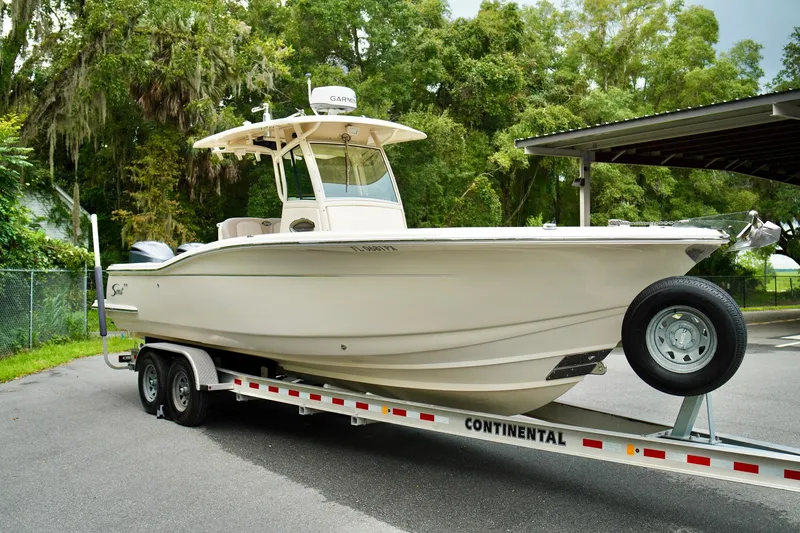 Slide: The Image of 2009 Scout 282 Sportfish boat on trailer, parked outdoors. - 3