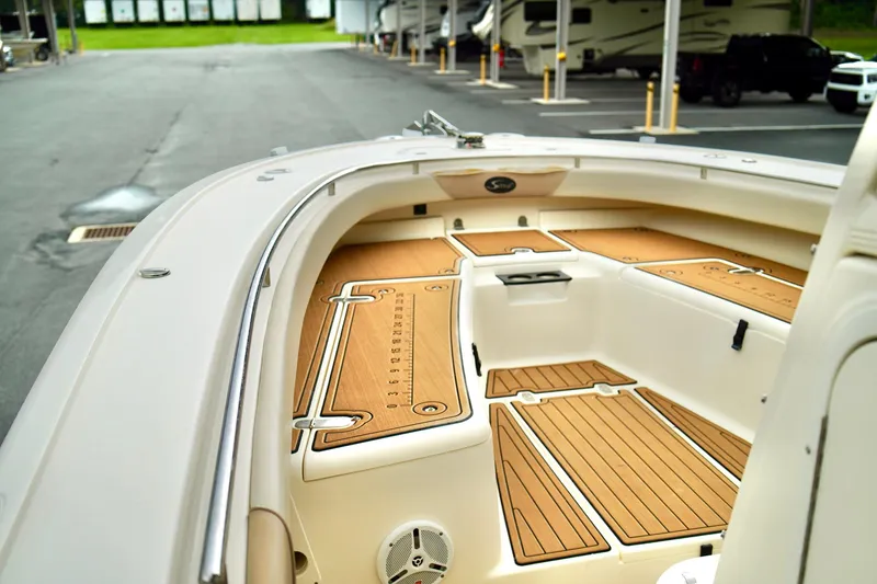 Slide: The Image of 2009 Scout 282 Sportfish boat with teak deck, parked near RVs. - 8