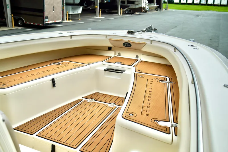 Slide: The Image of 2009 Scout 282 Sportfish boat interior with teak flooring and spacious deck layout. - 9