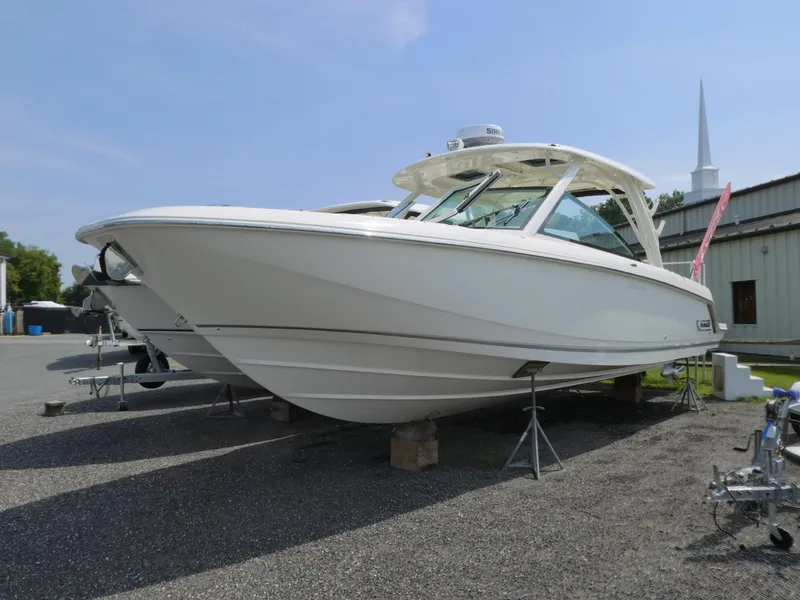 Slide: The Image of 2024 Boston Whaler 320 Vantage boat displayed outdoors on stands. - 0