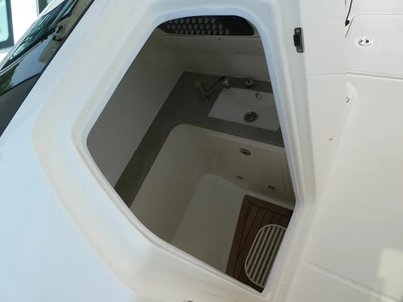 Slide: The Image of 2024 Boston Whaler 320 Vantage interior sink and storage area. - 10