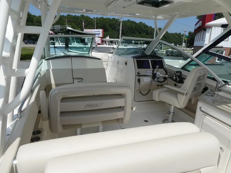 Slide: The Image of 2024 Boston Whaler 320 Vantage boat interior with helm and seating area. - 4