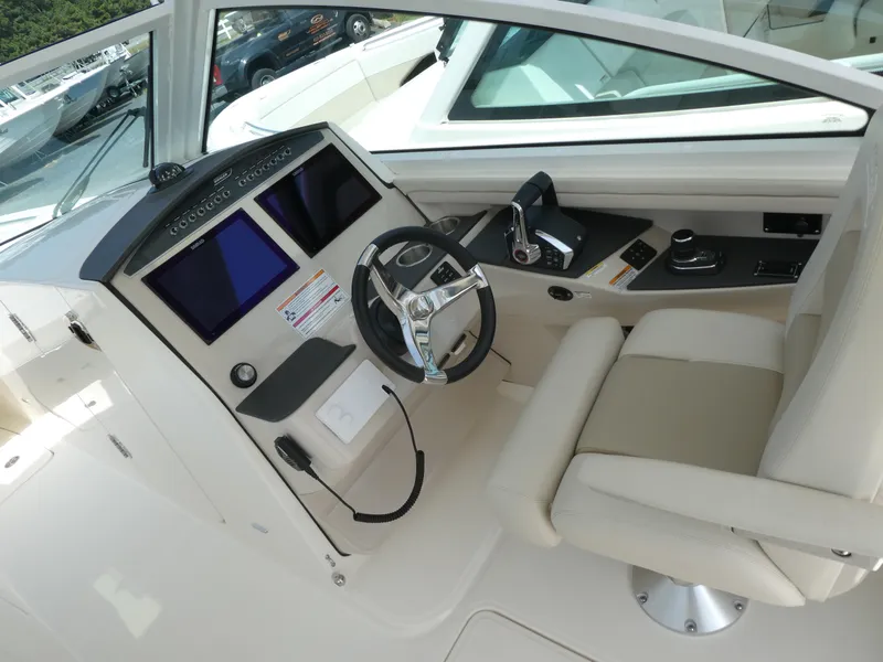 Slide: The Image of 2024 Boston Whaler 320 Vantage helm with dual screens and comfortable seating. - 5