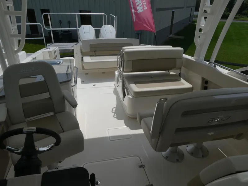 Slide: The Image of 2024 Boston Whaler 320 Vantage boat interior with seating and steering wheel. - 7