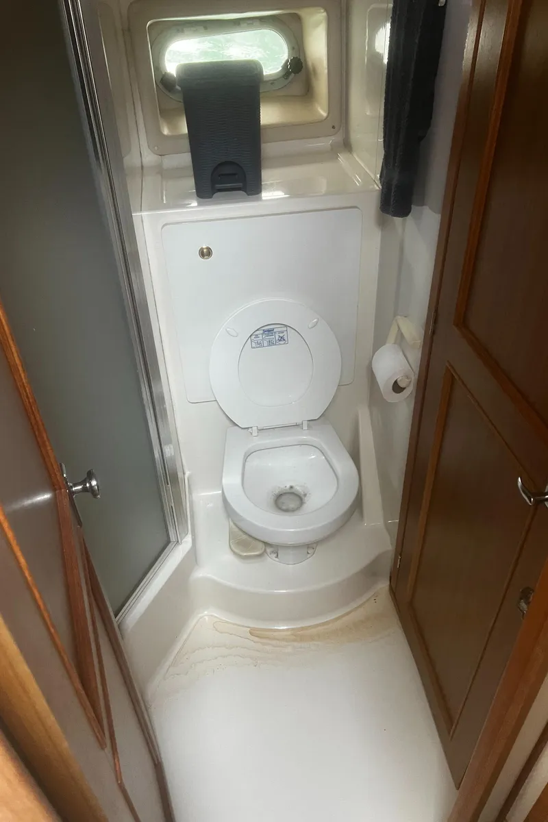 Slide: The Image of 2001 Bayliner 3788 Command Bridge Motoryacht bathroom with toilet and storage cabinets. - 32