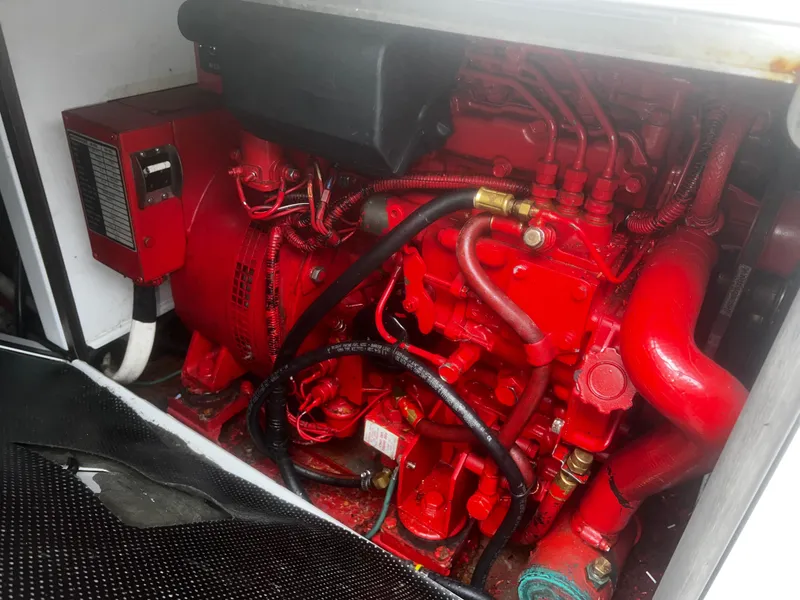 Slide: The Image of Engine compartment of a 2001 Bayliner 3788 Command Bridge Motoryacht, featuring a red engine. - 37