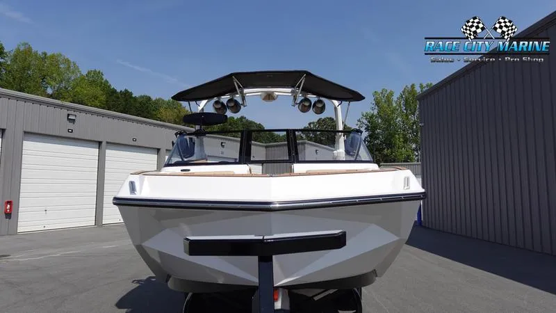 Slide: The Image of 2022 Nautique Super Air Nautique G23 boat in parking lot. - 3