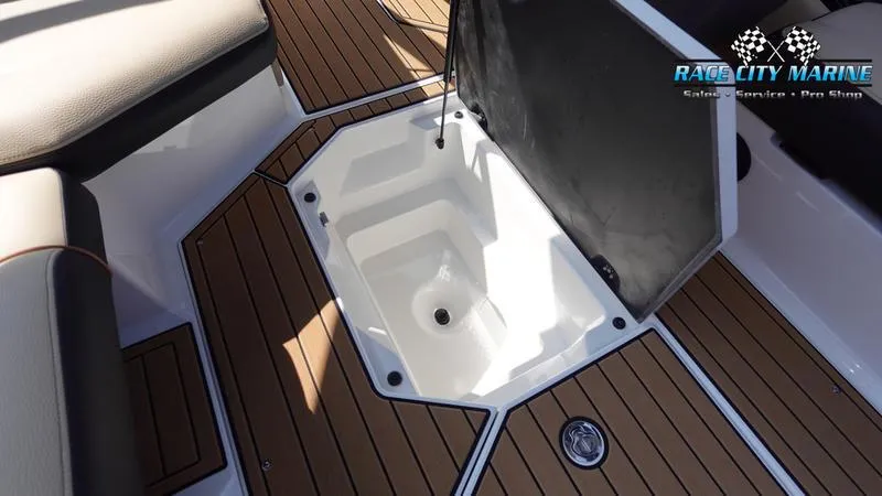 Slide: The Image of 2022 Nautique Super Air G23 boat with open storage compartment. - 6