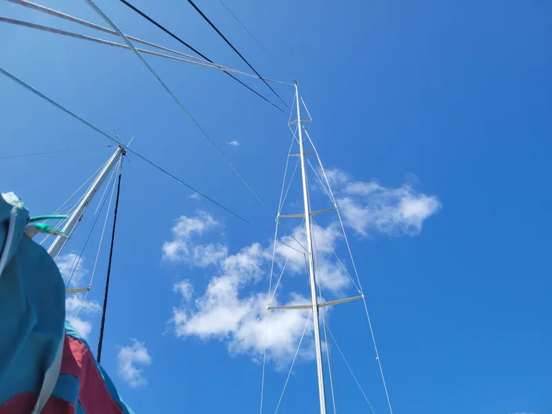 Slide: The Image of Mast of 1990 Nelson Marek IOR 50 Racing Sailboat against clear blue sky. - 10
