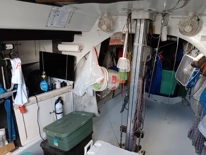 Slide: The Image of Interior of a 1990 Nelson Marek IOR 50 racing sailboat, featuring equipment and storage. - 17