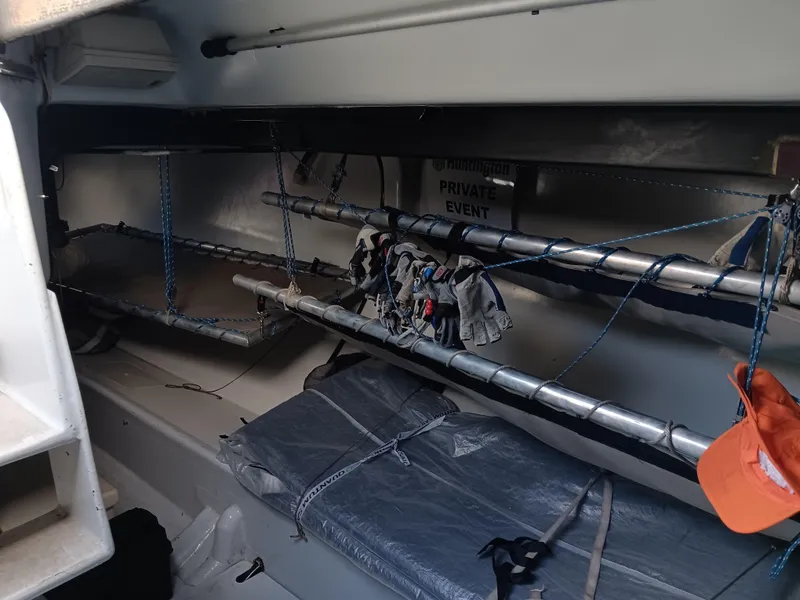 Slide: The Image of Interior of a 1990 Nelson Marek IOR 50 racing sailboat with bunks and gear storage. - 19