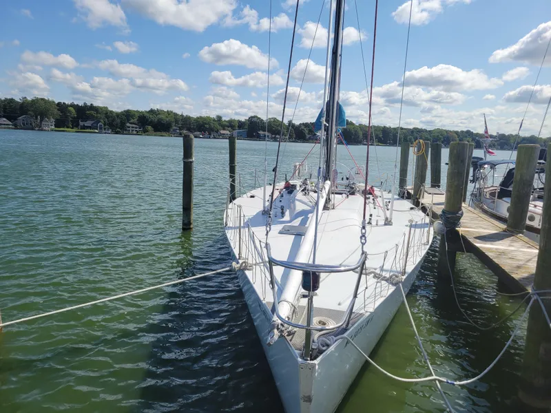 Slide: The Image of 1990 Nelson Marek IOR 50 Racing Sailboat docked on a sunny day. - 20
