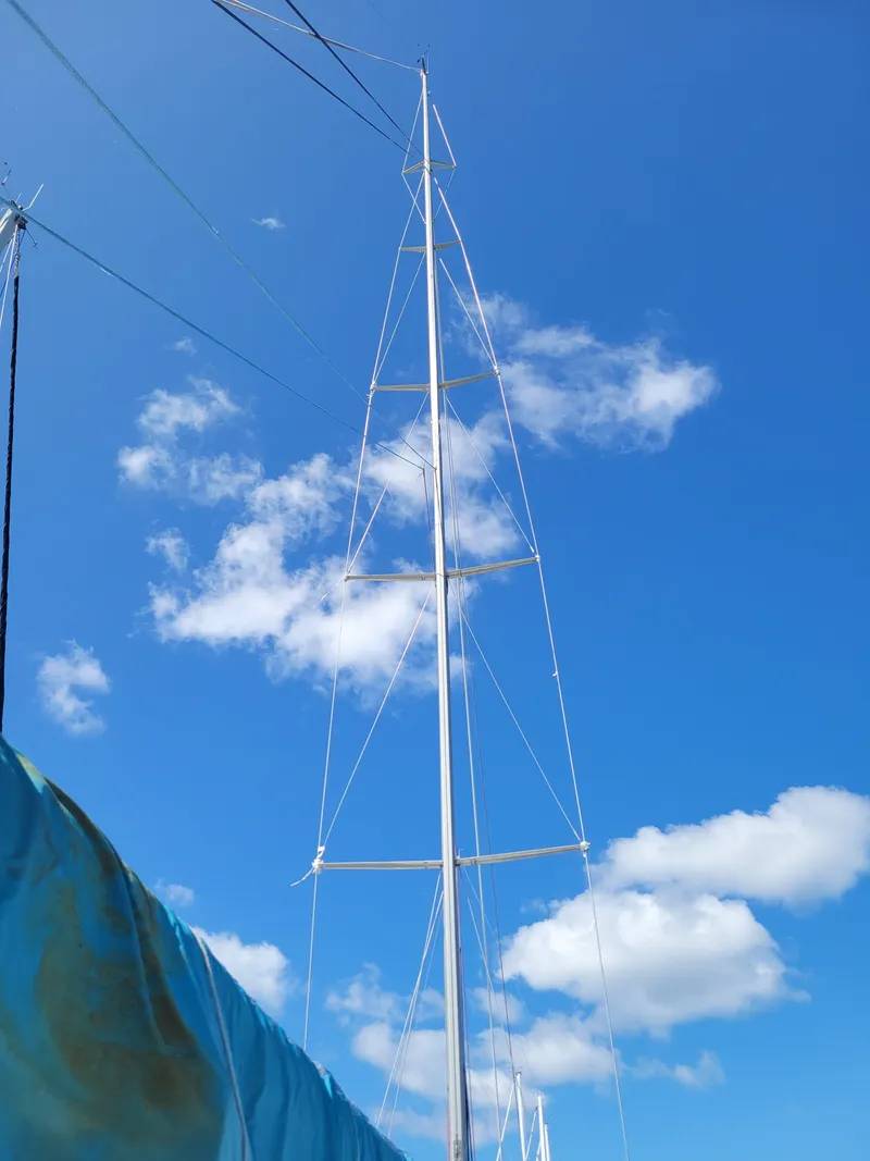 Slide: The Image of Tall mast of a 1990 Nelson Marek IOR 50 Racing Sailboat against a clear blue sky. - 9