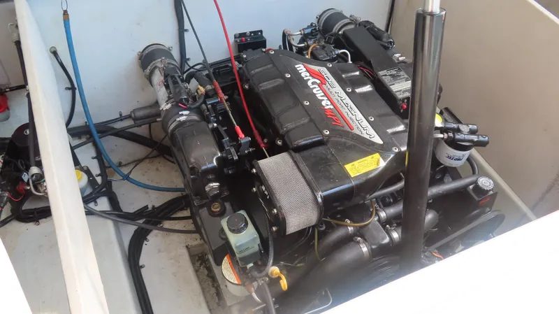 Slide: The Image of 1997 Envision Intruder 3200 engine compartment with MerCruiser engine components. - 12