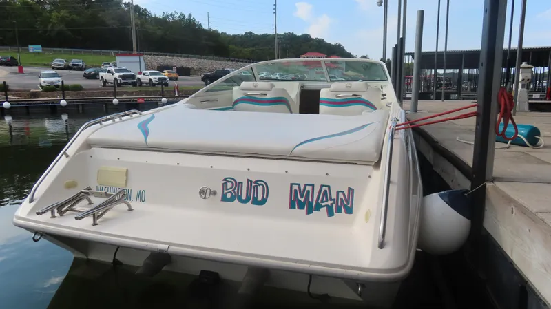 Slide: The Image of 1997 Envision Intruder 3200 boat docked, rear view with "Bud Man" text. - 2