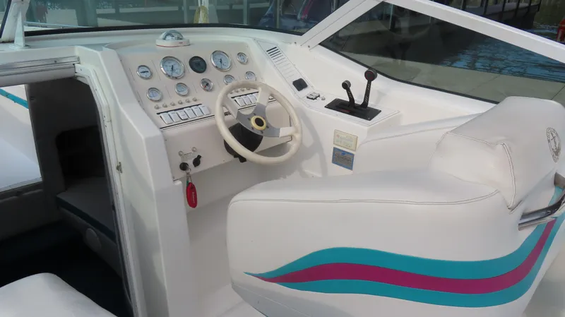 Slide: The Image of 1997 Envision Intruder 3200 boat cockpit with steering wheel and control panel. - 6