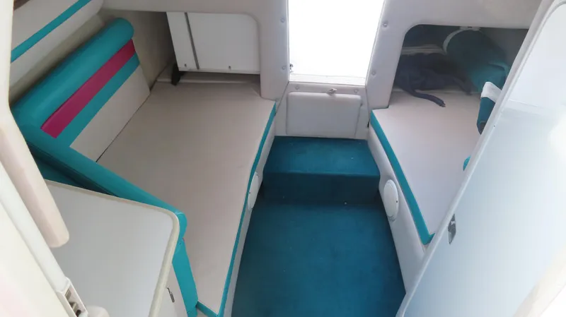 Slide: The Image of 1997 Envision Intruder 3200 cabin interior with teal and pink accents, featuring seating and storage. - 9