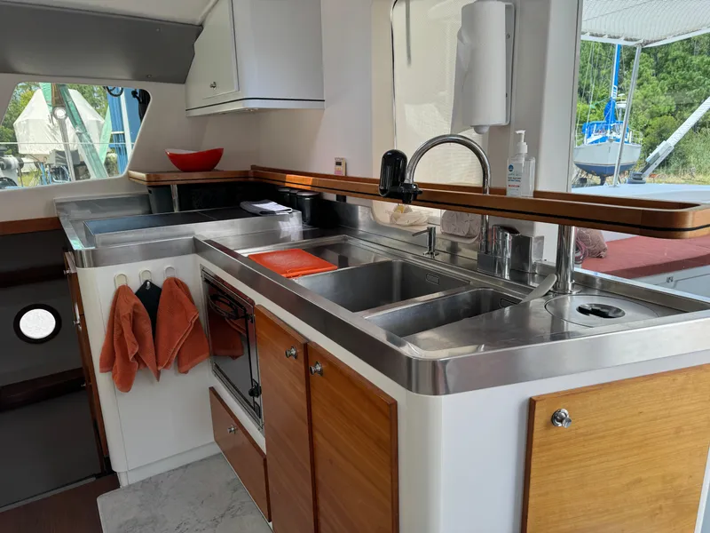 Slide: The Image of Modern kitchen interior of 2010 Outremer 49 yacht with stainless steel sink and wooden cabinets. - 10