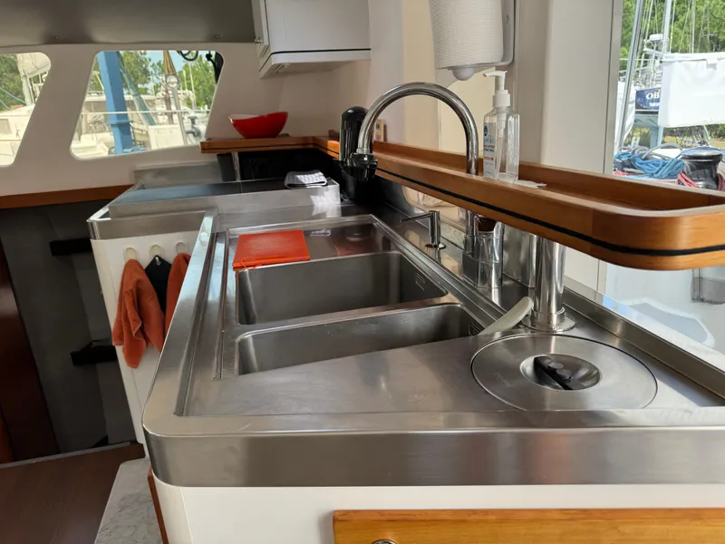 Slide: The Image of Modern kitchen area in a 2010 Outremer 49 yacht with stainless steel sink and faucet. - 11