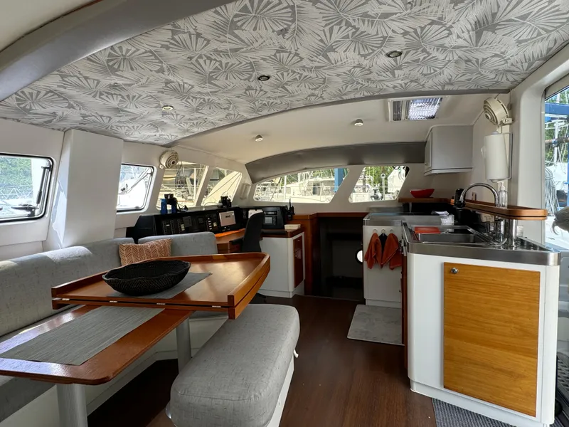 Slide: The Image of Interior of 2010 Outremer 49 yacht with modern kitchen and dining area. - 14