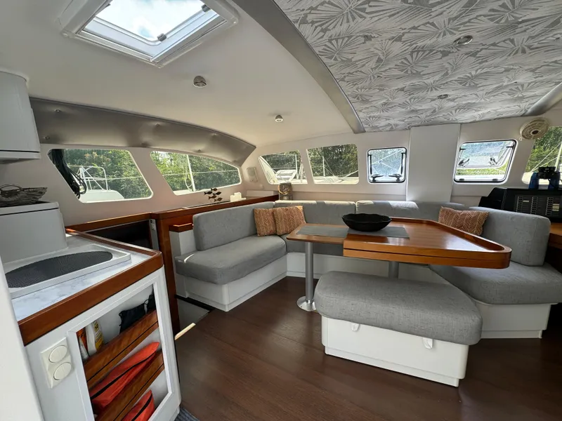 Slide: The Image of Luxurious interior of 2010 Outremer 49 yacht with modern seating and dining area. - 15