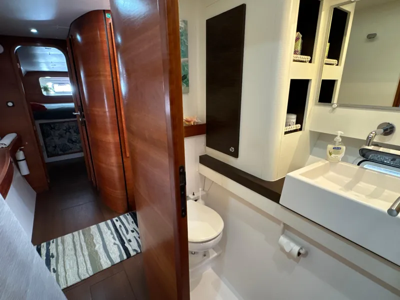 Slide: The Image of Bathroom interior of 2010 Outremer 49 yacht, featuring modern sink and wooden accents. - 17