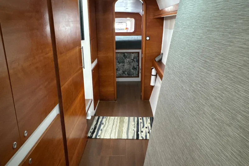 Slide: The Image of Interior of 2010 Outremer 49 yacht with wooden finishes and hallway view. - 18