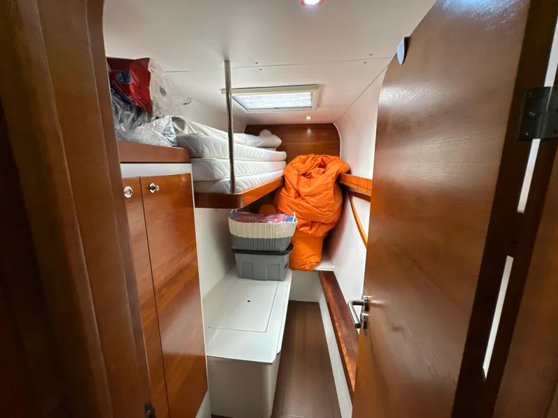 Slide: The Image of Cabin interior of 2010 Outremer 49 sailboat with storage and bedding. - 21