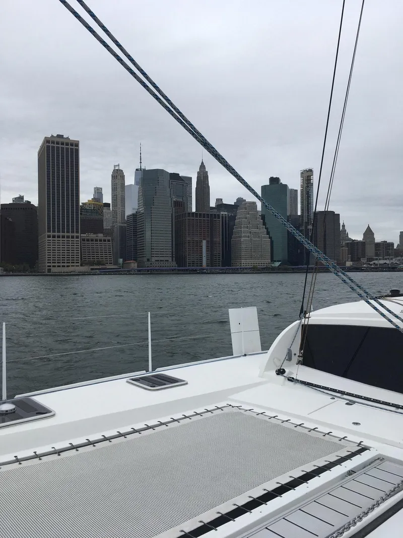 Slide: The Image of Outremer 49 catamaran sailing near city skyline, 2010 model. - 3