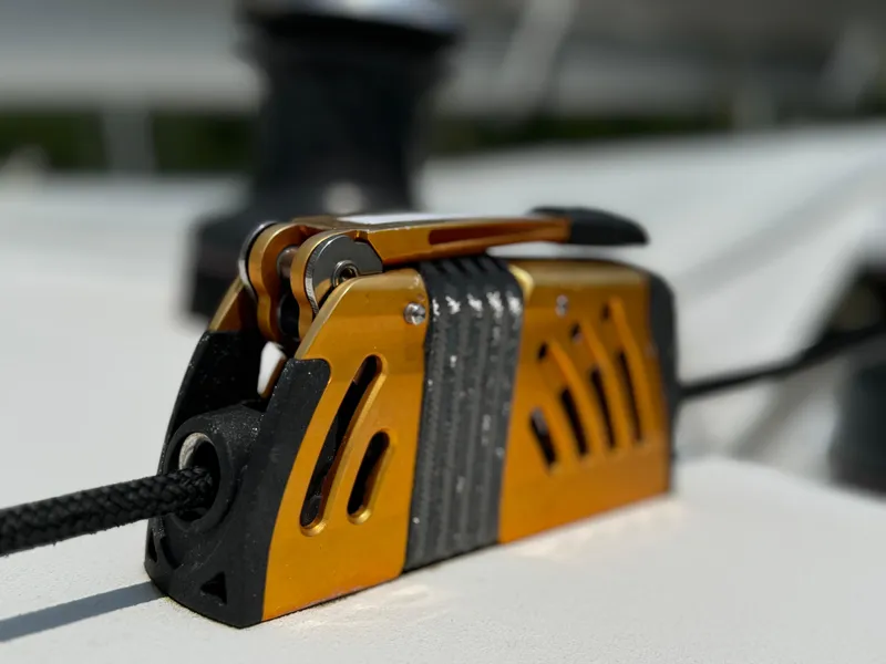 Slide: The Image of Close-up of a rope clutch on a 2010 Outremer 49 sailboat deck. - 34
