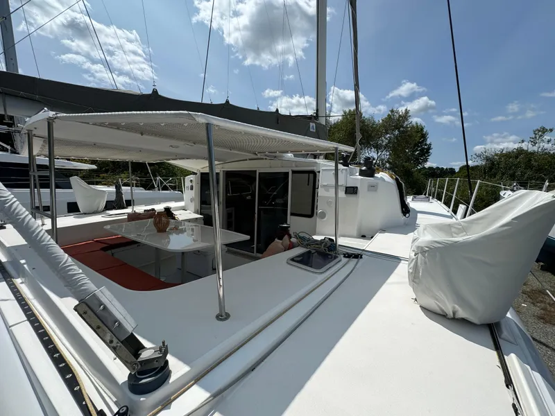 Slide: The Image of 2010 Outremer 49 catamaran with shaded deck, outdoor seating, and clear sky background. - 37