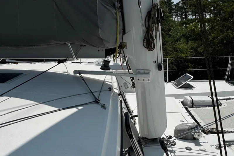Slide: The Image of 2010 Outremer 49 sailboat deck with rigging and forest backdrop. - 43