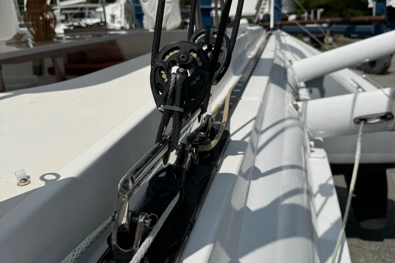 Slide: The Image of Close-up of rigging on a 2010 Outremer 49 sailboat, showcasing pulleys and ropes. - 47