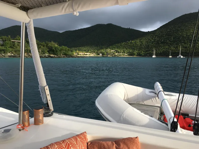 Slide: The Image of Outremer 49 catamaran, 2010 model, anchored in scenic bay with lush green hills. - 5