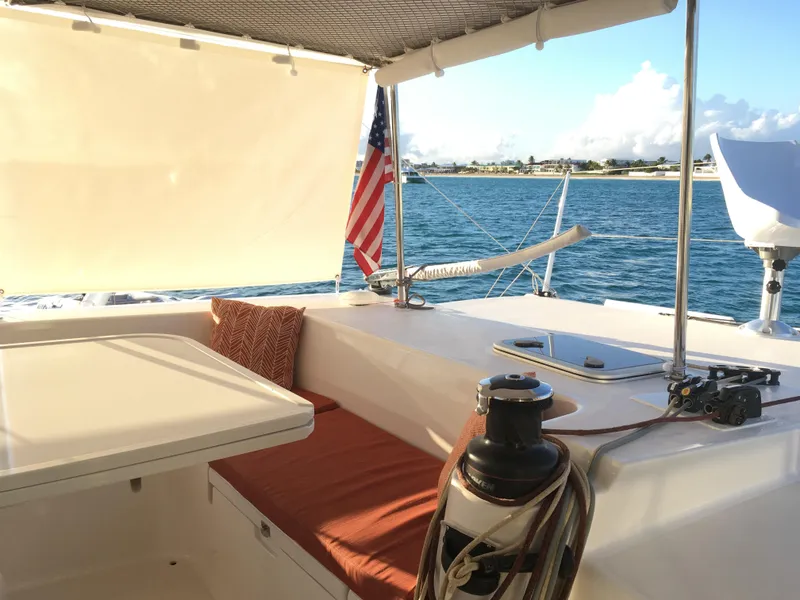 Slide: The Image of Outremer 49 catamaran deck with seating, table, and American flag, 2010 model. - 6