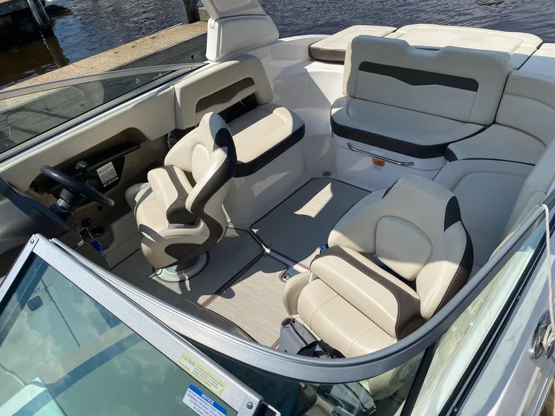 Slide: The Image of 2019 Chaparral 246 SSi boat interior with beige seating and steering wheel. - 4