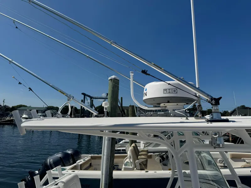 Slide: The Image of 2009 Regulator 32 Forward Seating boat with radar and fishing rods at dock. - 12