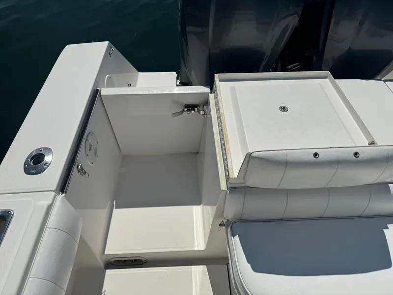 Slide: The Image of 2009 Regulator 32 Forward Seating boat interior with white seating and storage compartments. - 15
