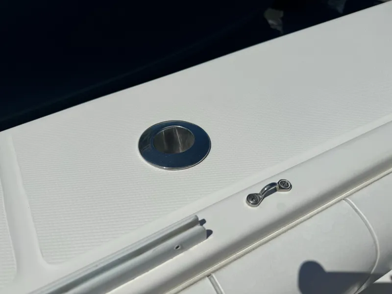 Slide: The Image of Close-up of 2009 Regulator 32 Forward Seating boat detail, featuring a metal fixture on white surface. - 16