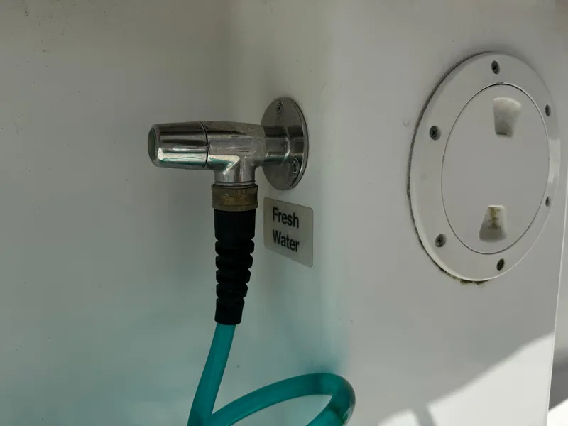 Slide: The Image of Fresh water hose connection on 2009 Regulator 32 Forward Seating boat. - 18