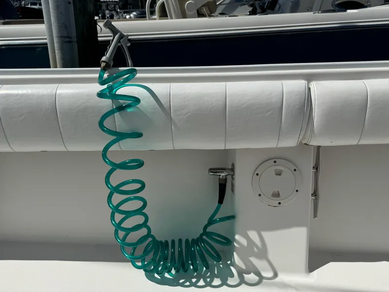 Slide: The Image of Coiled green hose on 2009 Regulator 32 Forward Seating boat deck. - 19