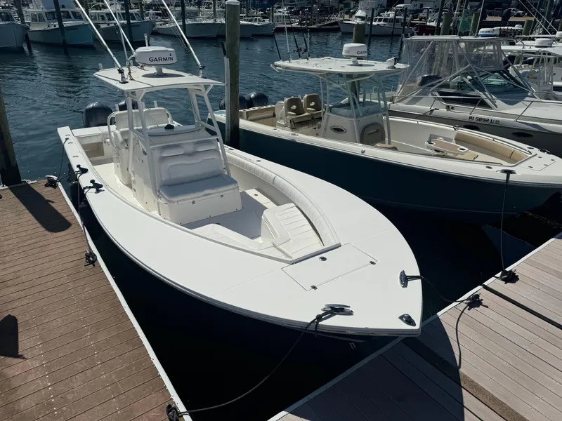 Slide: The Image of 2009 Regulator 32 Forward Seating boat docked at marina. - 2