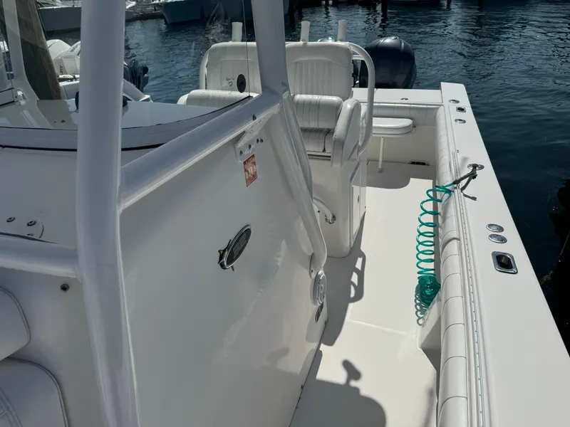 Slide: The Image of 2009 Regulator 32 Forward Seating boat, white interior, docked at marina. - 24
