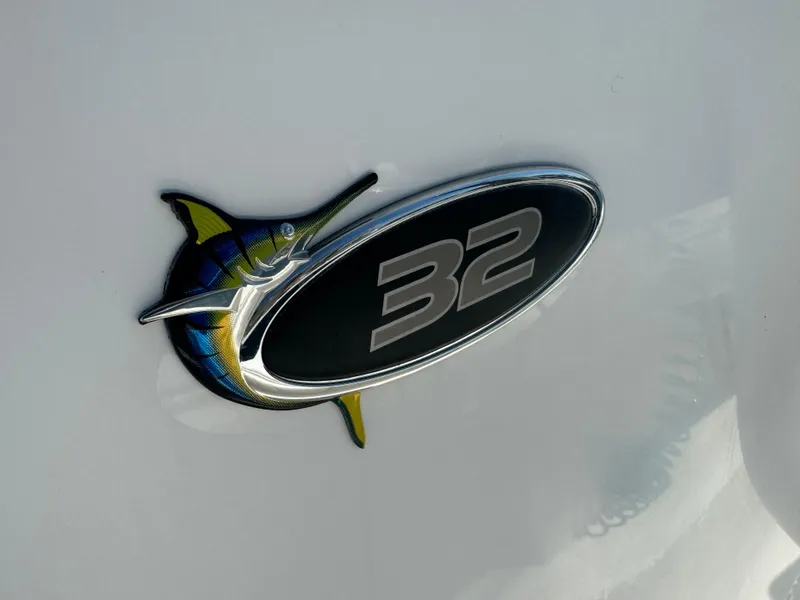 Slide: The Image of Regulator 32 Forward Seating 2009 emblem with marlin design on white background. - 25