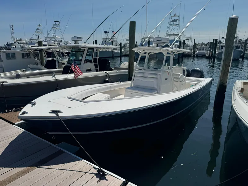 Slide: The Image of 2009 Regulator 32 Forward Seating boat docked in a marina. - 3