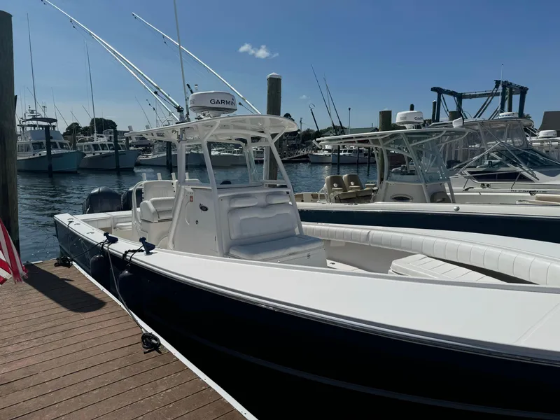Slide: The Image of 2009 Regulator 32 Forward Seating boat docked at marina. - 31