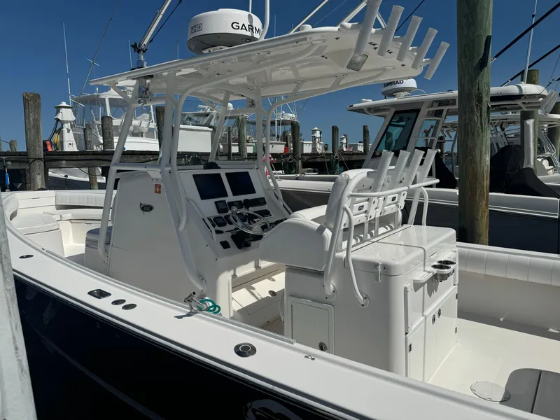 Slide: The Image of 2009 Regulator 32 Forward Seating boat with helm and seating, docked at marina. - 32