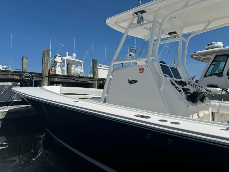 Slide: The Image of 2009 Regulator 32 Forward Seating boat docked at marina under clear blue sky. - 34