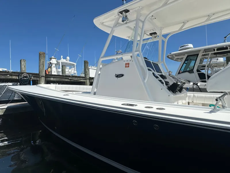 Slide: The Image of 2009 Regulator 32 Forward Seating boat docked at marina, side view. - 35